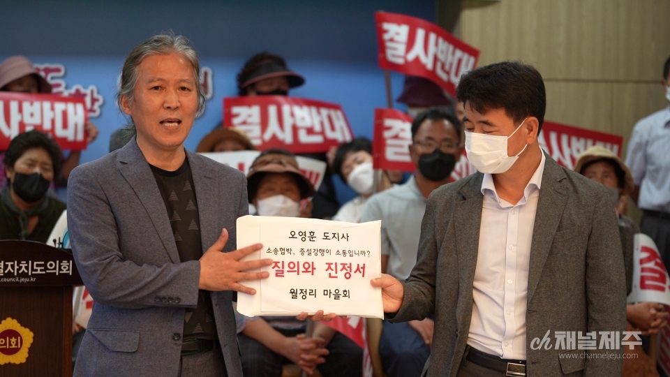 제주도지사 비서관에게 진정서를 제출하고 있다.